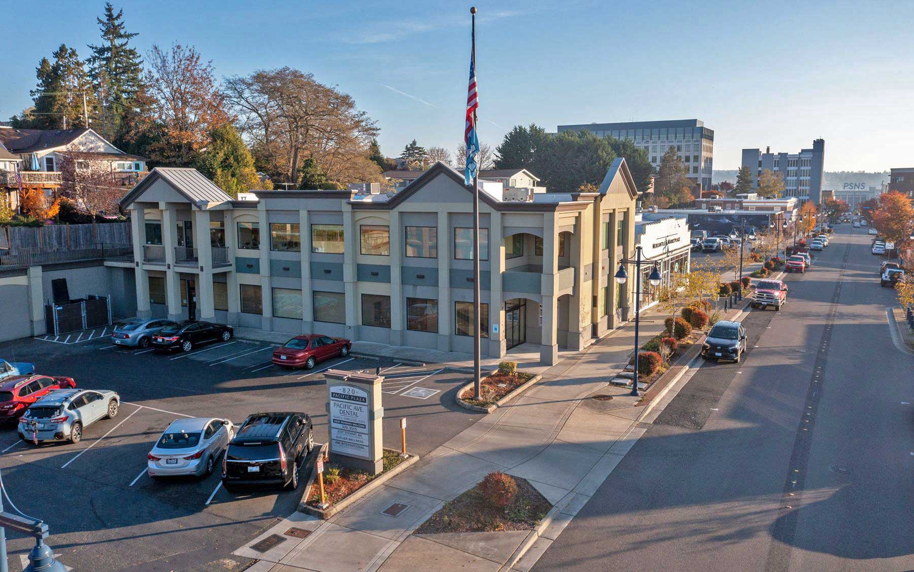 Pacific Plaza, the office building at 820 Pacific Avenue in downtown Bremerton, seen from the street with downtown behind it